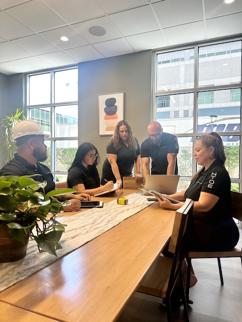 A team of inspectors around a meeting table having a discussion.