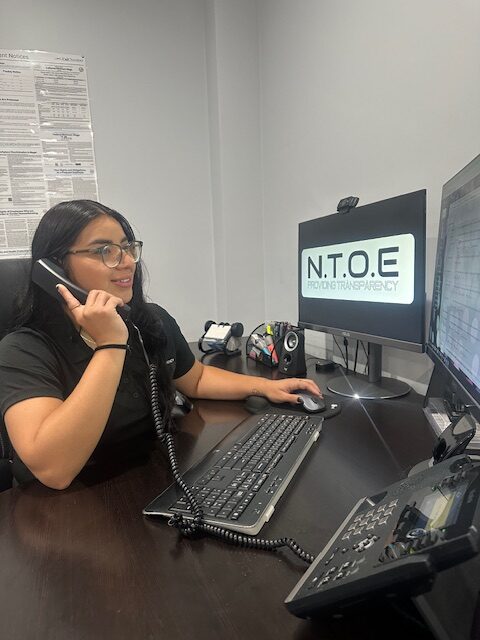 Inspector answering a call on her desk.