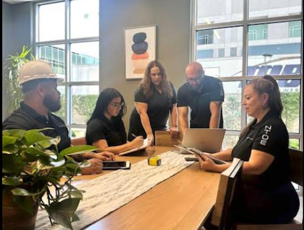 NTOE team gathering around a table.