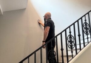 Owner of NTOE, Naz, checking the walls.